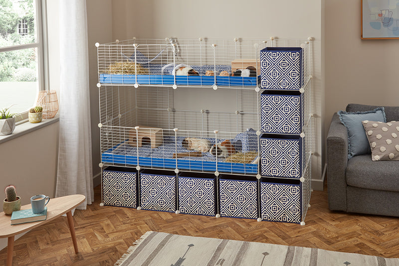 A double 4x2 c&c cage with stand and side storage for guinea pigs with two levels blue correx baby safe grids by brand kavee in the uk