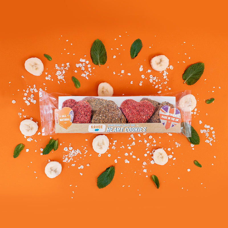 Kavee heart cookies with leaves bananas and oats behind on an orange background